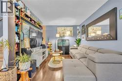Living area featuring wood-finish flooring and light blue walls - 