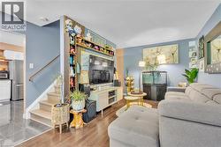 Hardwood-style flooring in the living area transitions to tile flooring - 