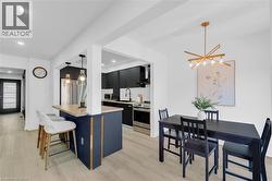 Kitchen with dark cabinetry and stainless steel appliances - 