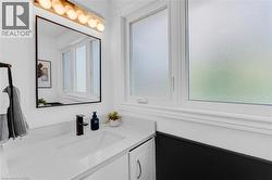 Modern vanity featuring an integrated sink, quartz countertop, and matte black faucet - 