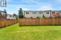 Expansive grassy lawn with a full privacy fence - 