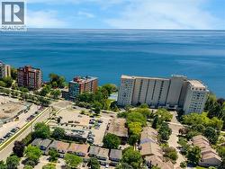 Expansive blue water backdrop with diverse architectural styles, including multi-story residences and commercial structures - 
