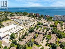 Aerial perspective featuring a body of water, residential properties, and commercial buildings - 