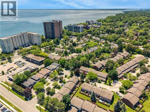 Aerial perspective showcasing a residential community with abundant mature trees and proximity to a large body of water - 5275 Banting Court, Burlington, ON 