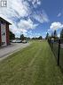 Expansive grass area with a chain-link fence border - 26 Carnaby Crescent, Kitchener, ON 