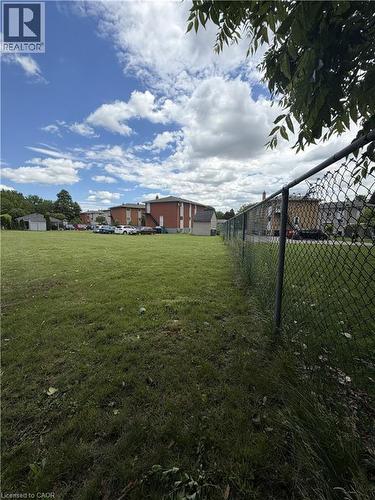 Expansive green space featuring a chain-link perimeter fence - 26 Carnaby Crescent, Kitchener, ON 