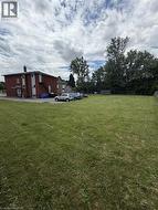 Expansive grassy lot with mature perimeter trees - 