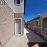 Brick and siding exterior featuring a side entrance door - 59 Highgate Road Unit# 2, Kitchener, ON 