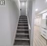 Staircase featuring wood-finish treads with white risers and handrail - 59 Highgate Road Unit# 2, Kitchener, ON 