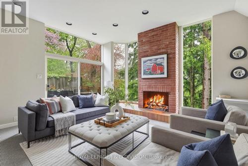 Family Room w Gas Fireplace and ravine views - 41 Ridge Drive, Toronto, ON 
