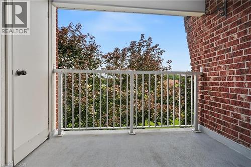 Balcony featuring a concrete surface, white metal railing, and a red brick exterior wall - 117 E Bristol Road E Unit# 64, Mississauga, ON 