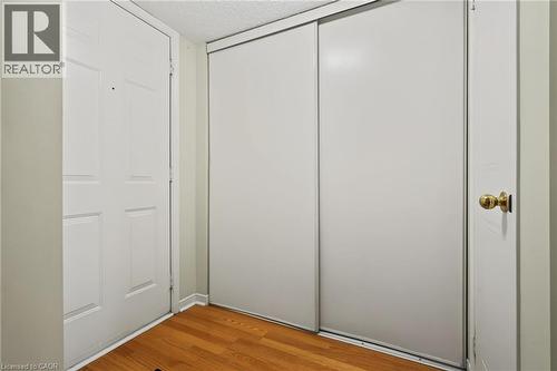 Hardwood-finish flooring, white paneled door, brass hardware, and sliding closet doors - 117 E Bristol Road E Unit# 64, Mississauga, ON 