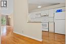 Kitchen featuring white cabinetry, white appliances, and a tile backsplash - 117 E Bristol Road E Unit# 64, Mississauga, ON 
