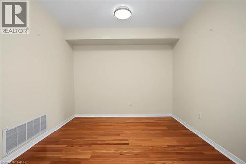 Room featuring wood-finish flooring, light neutral wall paint, and white baseboards - 117 E Bristol Road E Unit# 64, Mississauga, ON 