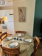 Open living area with wood-finish flooring and a large window providing abundant natural light - 