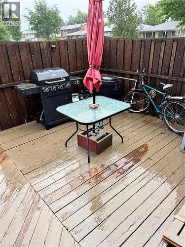 Wooden deck featuring a diagonal board pattern and a privacy fence - 227 Fergus Avenue, Kitchener, ON 