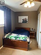 Living space featuring wood-finish flooring, light green wall paint, and a textured white ceiling - 