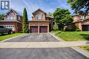 Brick facade residence featuring a double-door garage and a paved driveway - 5 Shetland Drive, Waterdown, ON 