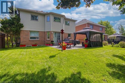 Expansive backyard featuring a large green lawn and a paver patio with a gazebo - 5 Shetland Drive, Waterdown, ON 