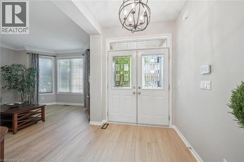 Foyer with a chandelier, arches, and Living Room with large windows - 79 Zieman Crescent, Cambridge, ON 