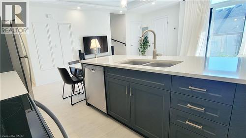 Kitchen island featuring a dual-basin stainless steel sink with a gooseneck faucet - 142 Foamflower Place Unit# 12, Waterloo, ON - Indoor Photo Showing Kitchen With Double Sink