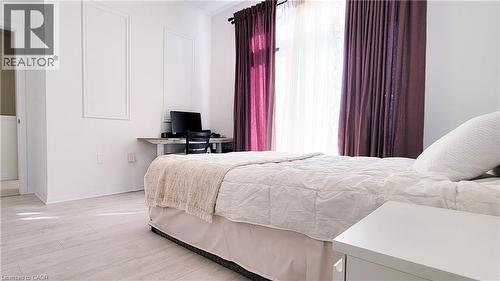 Bright interior with light wood-finish flooring - 142 Foamflower Place Unit# 12, Waterloo, ON - Indoor Photo Showing Bedroom