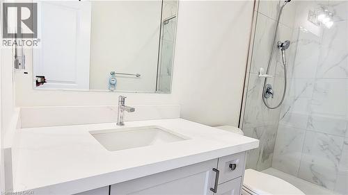 Modern bathroom featuring a single vanity with an undermount sink, a polished chrome faucet, and a large wall-mounted mirror - 142 Foamflower Place Unit# 12, Waterloo, ON - Indoor Photo Showing Bathroom