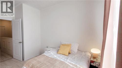 Light-filled room featuring neutral wall tones and wood-finish flooring - 142 Foamflower Place Unit# 12, Waterloo, ON - Indoor Photo Showing Bedroom