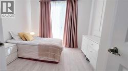 Light wood-finish flooring complements the neutral wall color - 