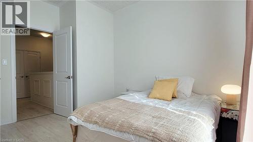 Neutral wall paint in a bedroom with light wood-finish flooring - 142 Foamflower Place Unit# 12, Waterloo, ON - Indoor Photo Showing Bedroom