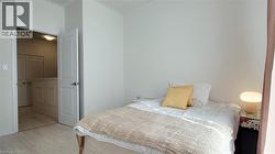 Neutral wall paint in a bedroom with light wood-finish flooring - 