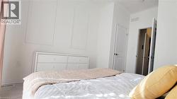 Bright interior space featuring light-colored walls and flooring, accented by wainscoting detailing - 