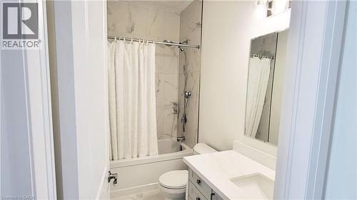 Bathroom featuring a white vanity with a rectangular undermount sink, a white countertop, and a mirrored medicine cabinet - 142 Foamflower Place Unit# 12, Waterloo, ON - Indoor Photo Showing Bathroom