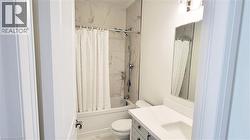 Bathroom featuring a white vanity with a rectangular undermount sink, a white countertop, and a mirrored medicine cabinet - 