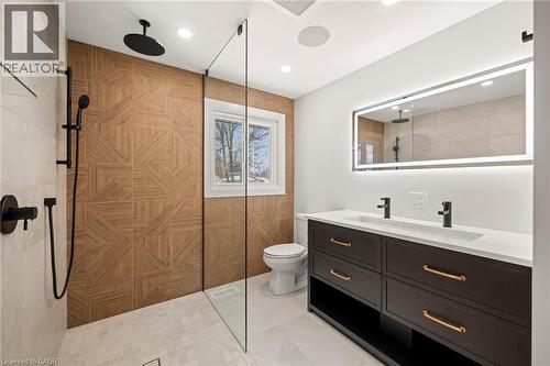 Contemporary bathroom featuring a walk-in shower with patterned wood-finish wall tile and matte black fixtures - 361 Coleridge Place, Waterloo, ON - Indoor Photo Showing Bathroom