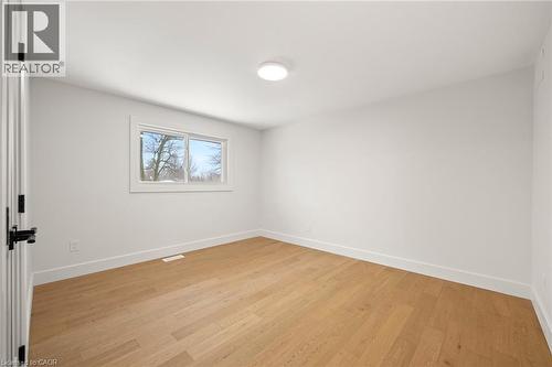 Light wood-finish flooring complemented by white baseboards and walls - 361 Coleridge Place, Waterloo, ON - Indoor Photo Showing Other Room
