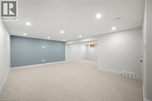 Spacious room featuring light-colored carpeting, recessed lighting, and a prominent accent wall - 361 Coleridge Place, Waterloo, ON - Indoor