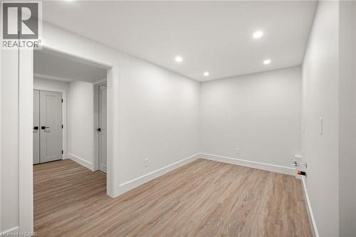 Bright room featuring wood-finish flooring, recessed lighting, and crisp white walls - 361 Coleridge Place, Waterloo, ON - Indoor Photo Showing Other Room