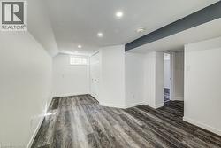 Interior space featuring wood-finish flooring, recessed lighting, and a white bi-fold closet door - 