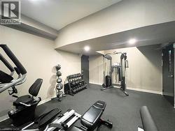 Dedicated fitness space featuring rubber flooring, recessed lighting, and neutral wall tones - 