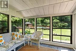 Sunroom overlooks gardens and pool - 