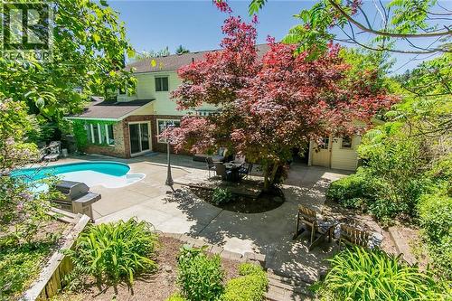 Large yard with mature trees, deck, patio and play areas - 1774 Old Mill Road, Kitchener, ON - Outdoor With In Ground Pool