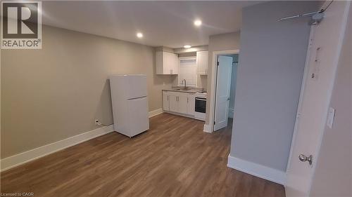 Kitchen: sink, stove, fridge + living/bedroom area - 181 King Street E Unit# 8, Kitchener, ON 