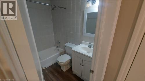 Full bathroom with sink, mirror, tub/shower and toilet - 181 King Street E Unit# 8, Kitchener, ON 