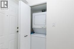 Dedicated laundry closet featuring a stacked washer and dryer unit - 