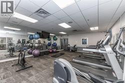 Fitness center featuring cardio equipment, strength training machines, and mirrored walls - 