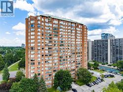 High-rise residential building featuring a brick exterior and numerous window units - 