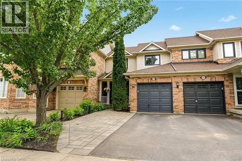 Brick and siding exterior with dark-framed windows - 2089 Broadleaf Crescent, Burlington, ON 