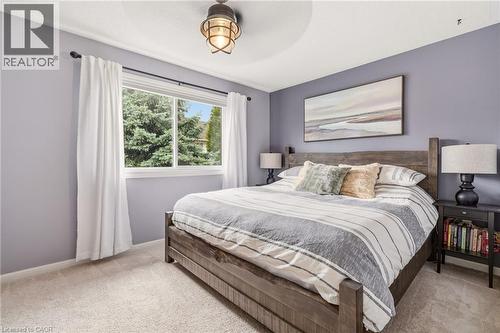 Spacious room featuring a large window, light-colored carpeting, and a ceiling-mounted light fixture - 2089 Broadleaf Crescent, Burlington, ON 
