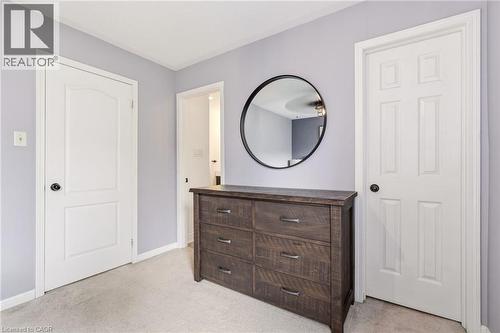 Light grey wall paint with white trim, two paneled doors, and light-colored carpeting - 2089 Broadleaf Crescent, Burlington, ON 